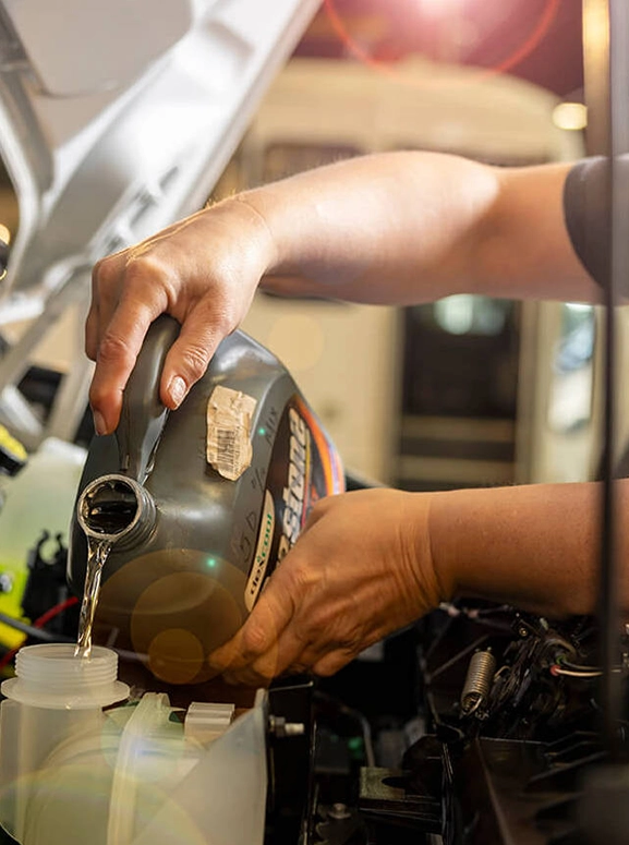 liquid pouring into a spout inside an engine